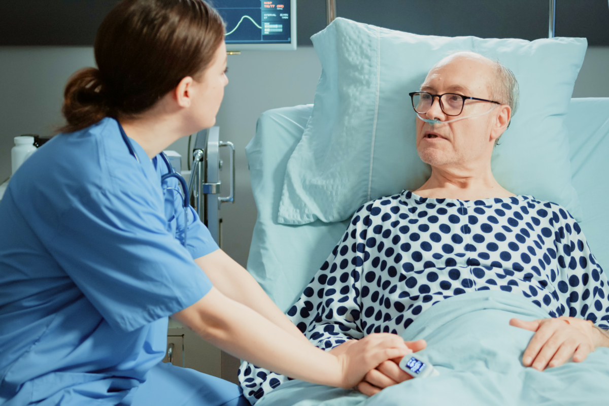 nurse-from-hospital-ward-tends-sick-old-patient-bed 1