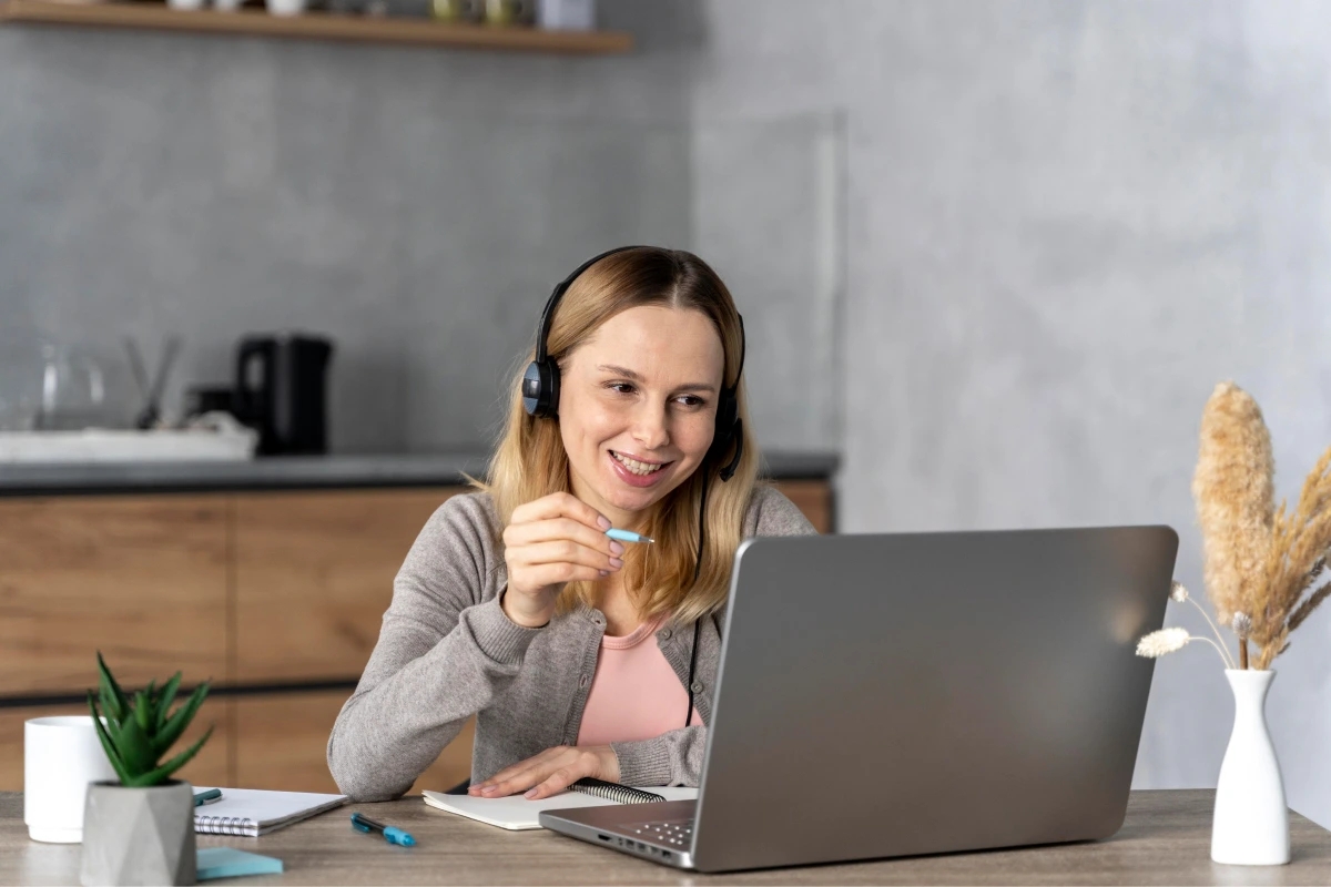 woman-with-headset-working-laptop 1