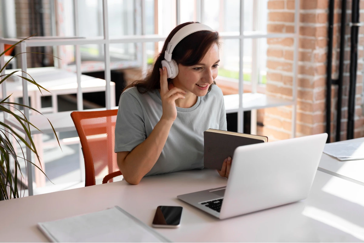 woman-working-with-headphones-medium-shot 1