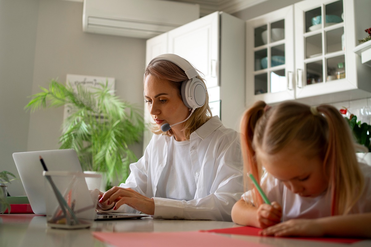 mother-working-from-home-trying-balance-family-life-with-child-job 1